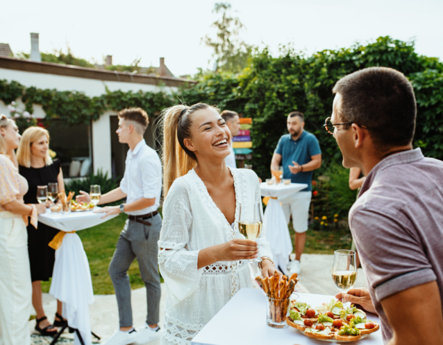 Guests and couple laughing together at engagement party