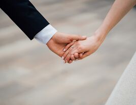 Bride and groom holding hands