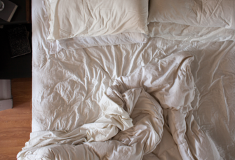 Overhead view of unmade bed