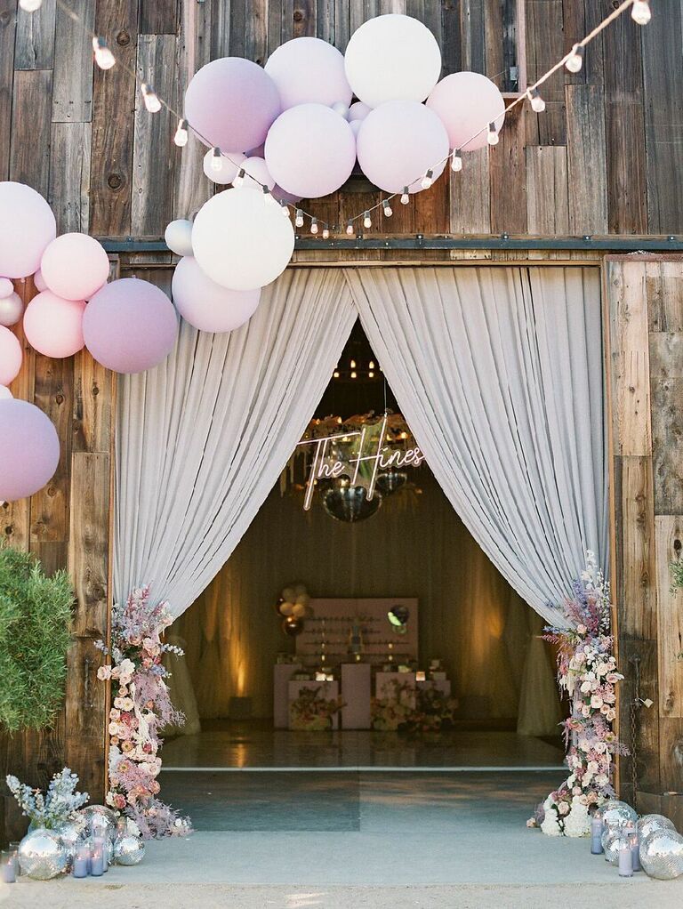 Ballons over wedding entrance with flowers and disco balls