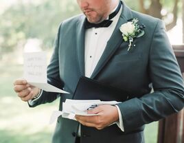 A groom reads a letter from their spouse on their wedding day.