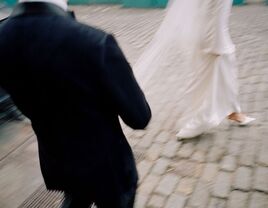 Blurry wedding phot of bride and groom walking