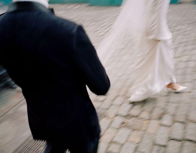 Blurry wedding phot of bride and groom walking