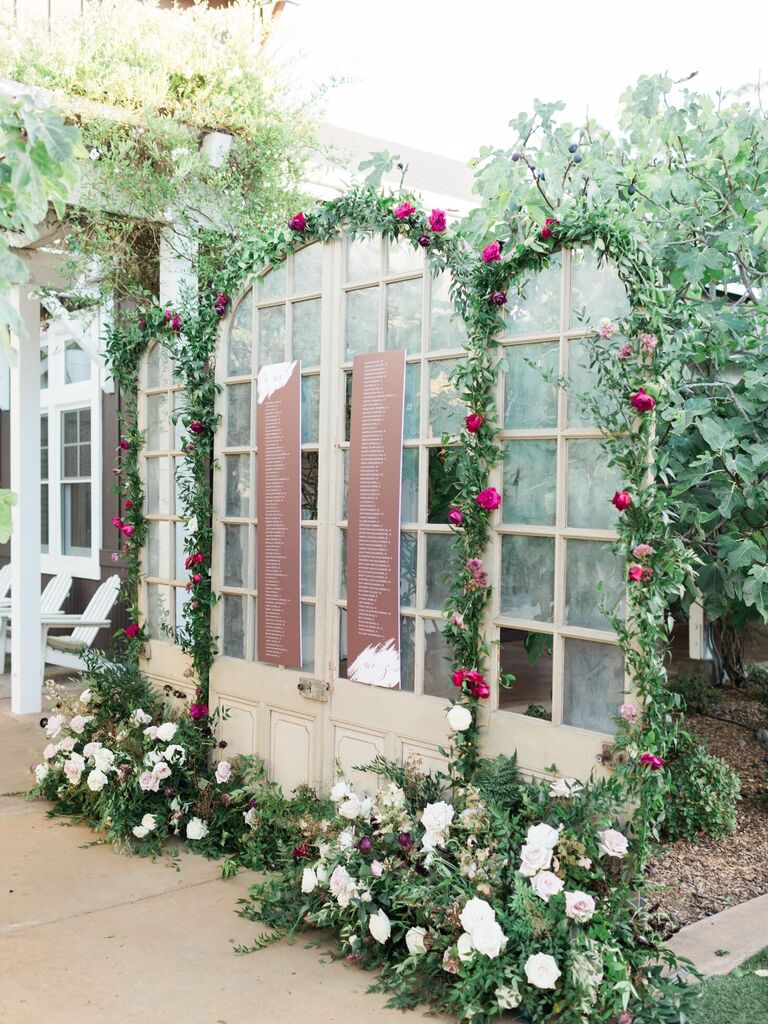 Seating chart surrounded by greenery arches