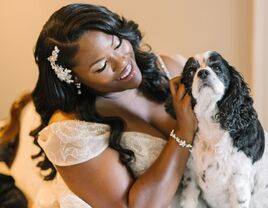 bride petting dog on wedding day