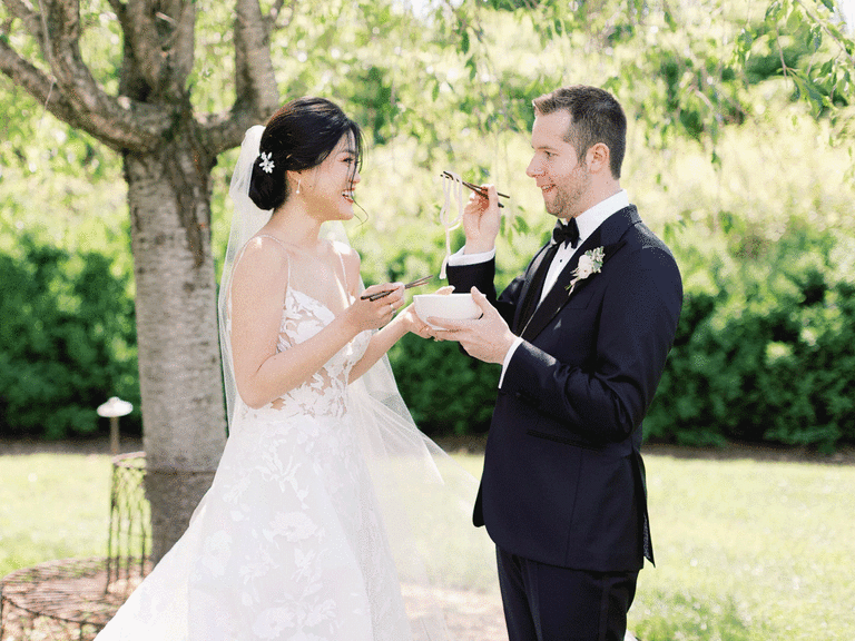 Bride and groom share noodles for a first meal first look alternative.