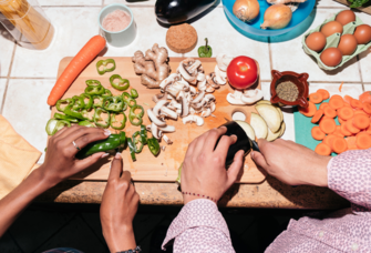 Couple chopping vegetables, grocery budget for two