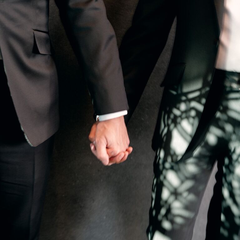 couple holding hands on wedding day