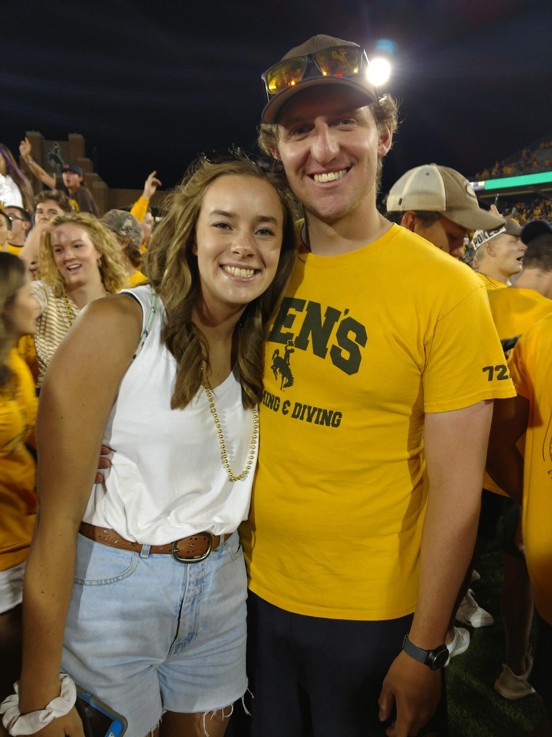 Kyle and Kiana "storming the field" after a University of Wyoming football win!