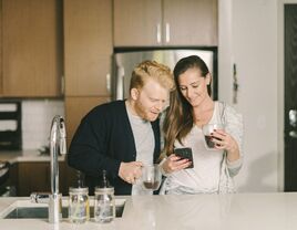 Couple registering from gifts on phone at home
