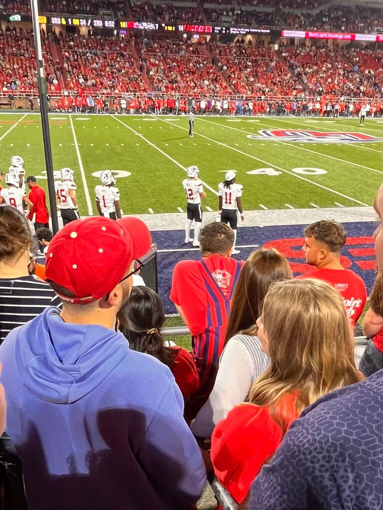 During a visit to Lynchburg, Josh reached out to Hannah and asked to take her on a date (and Hannah was over the moon excited about it hehe). One of their first outings was a Liberty Football game, where they spent the evening enjoying the game and each other’s company. Coincidentally, someone snapped a photo of them, unknowingly capturing one of their first dates.