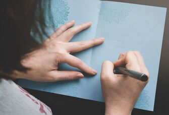 Woman writing in card.