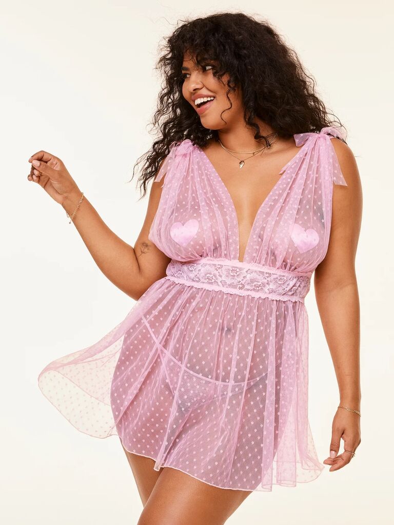 Model wears a romantic pink nightgown with a polka dot pattern. 