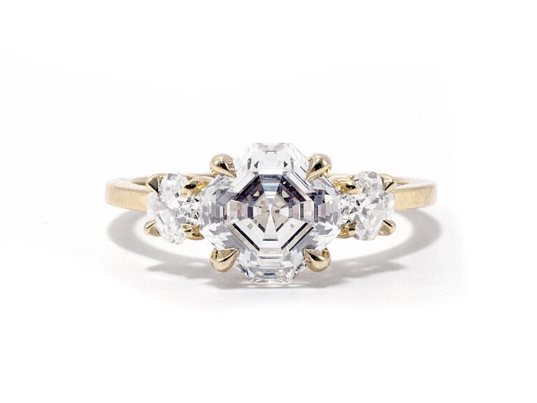 ashley zhang jewelry three stone asscher cut engagement ring with diamond center stone two side diamonds yellow gold claw prongs and plain yellow gold band