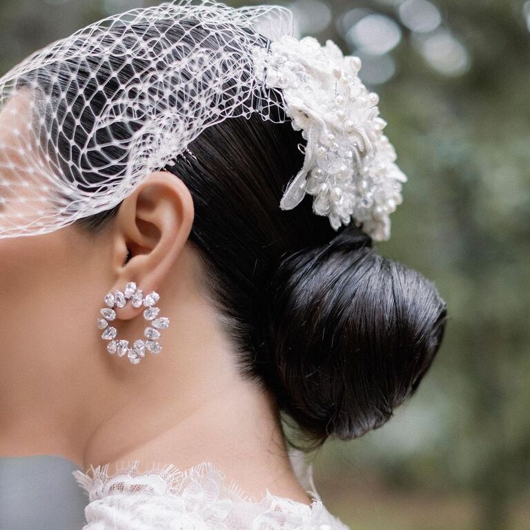 Accessorized bun wedding hairstyle for high neck dress