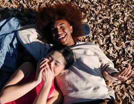 Couple laying down on the ground and laughing