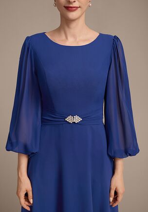 This beautiful dress is made from chiffon, offering an elegant and lightweight fit. It features a flattering scoop neckline with delicate flutter sleeves and is adorned with a sparkling embellishment at the waist for added glamour. The design is completed with a flowing A-line skirt that moves gracefully with every step, making it perfect for any special occasion.