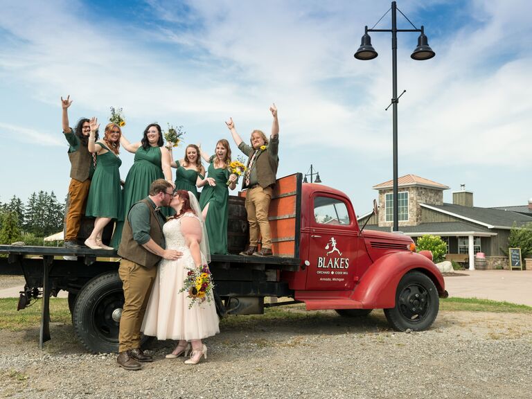 Couple and their guests standing on a red truck