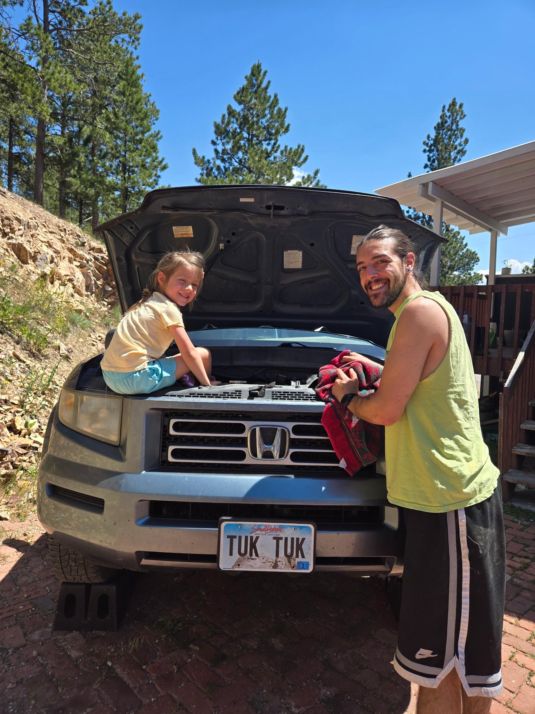 Daddy daughter time teaching Ada basic car maintenance