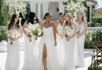 bride with bridesmaids wearing white dresses