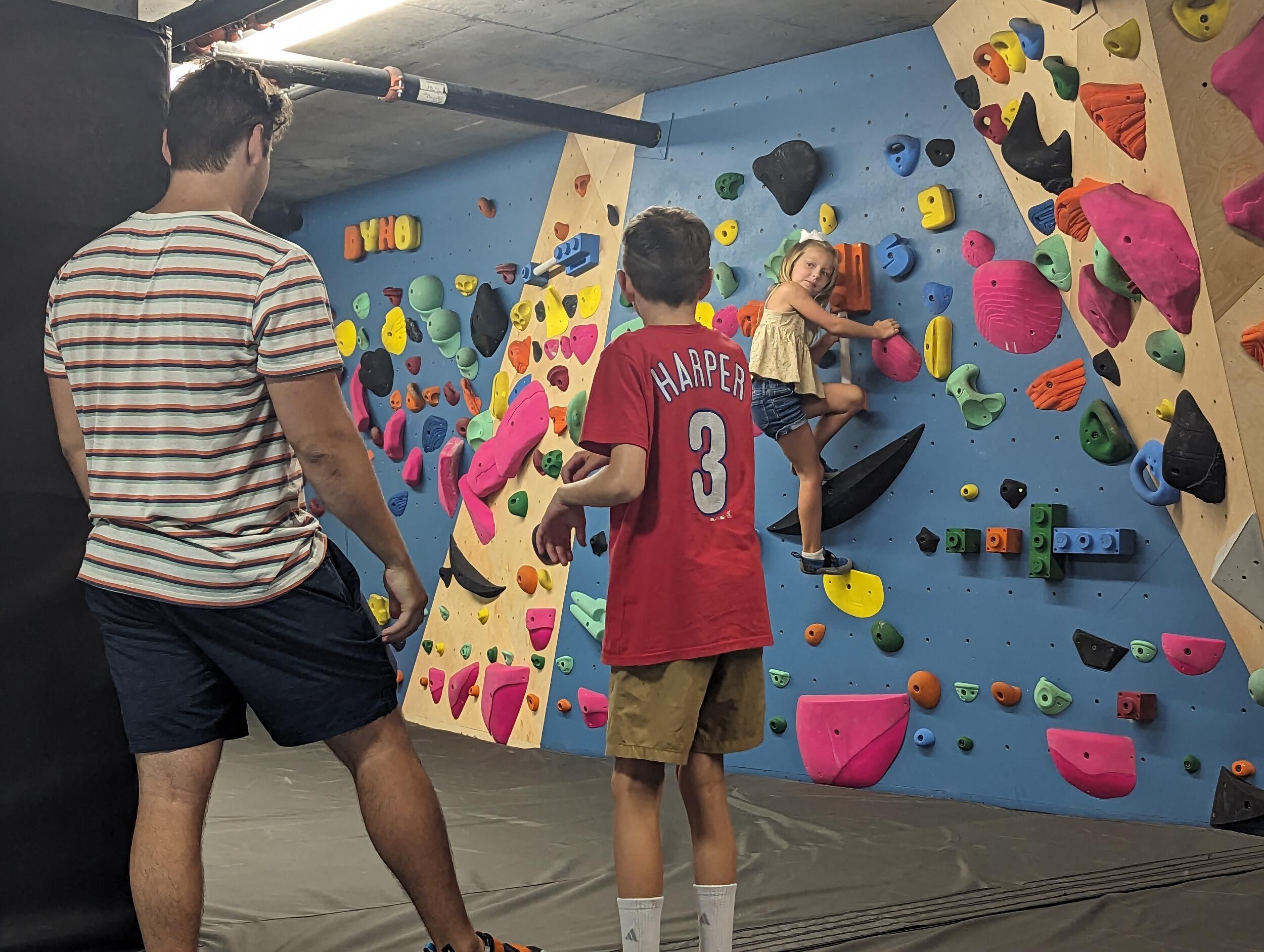 Aaron teaches Bridget's two youngest siblings how to boulder, one of his favorite activities.