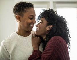 Couple hugging each other at home.