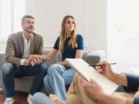 Couple holding hands while at marriage counseling