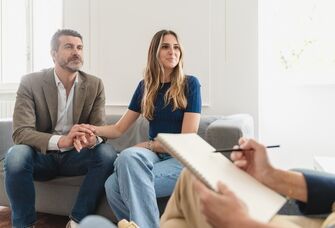 Couple holding hands while at marriage counseling