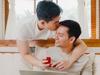 young same sex male couple getting engaged 