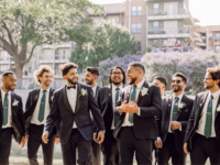 Groomsmen smiling with each other on wedding day