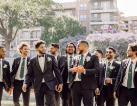 Groomsmen smiling with each other on wedding day