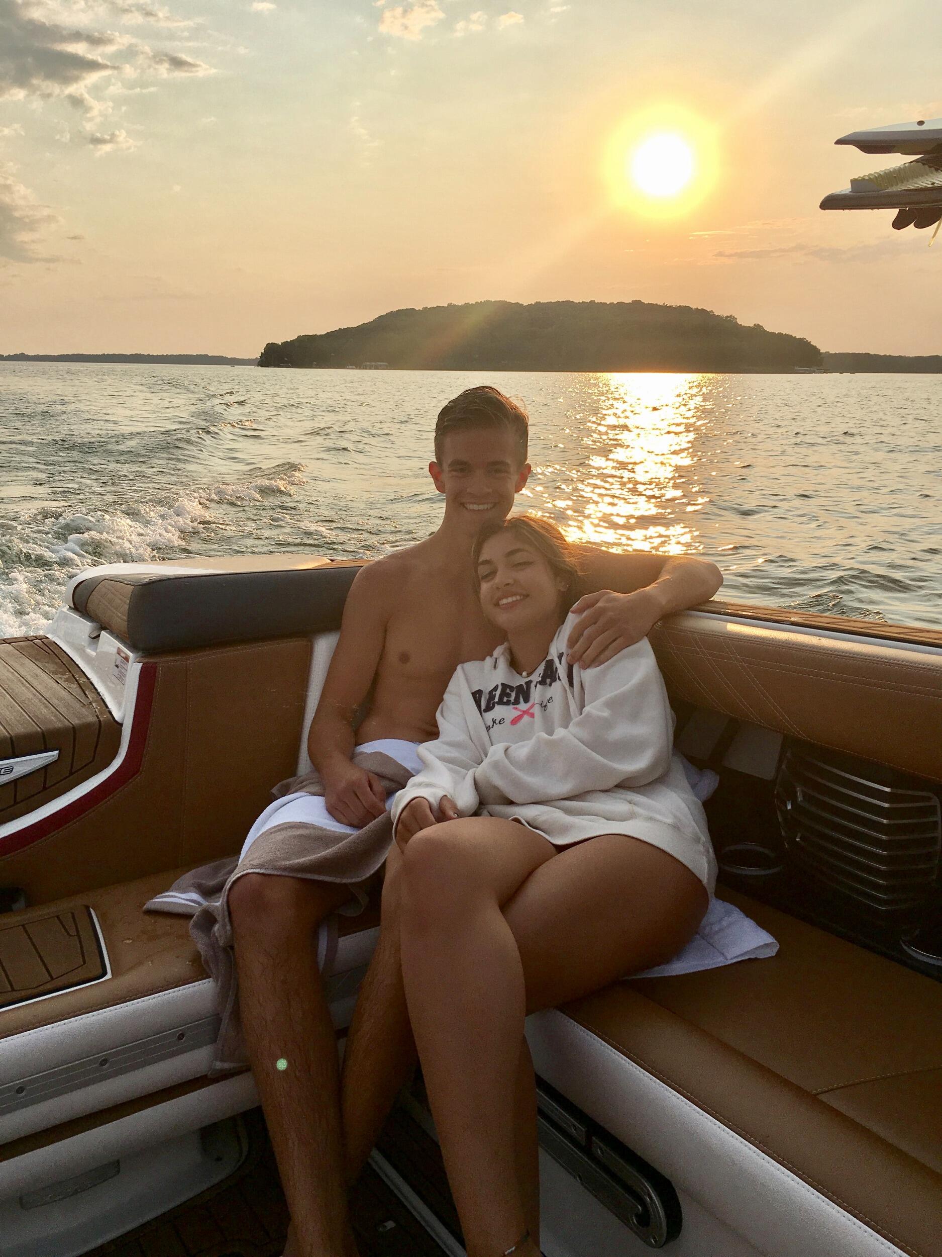 Connor asks Mia to be his girlfriend on a bench in front of his family's lake house.