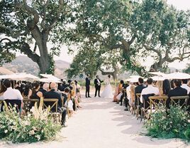 A couple say "I do" at their outdoor vineyard wedding