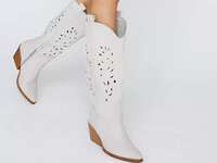 Stylish white cowboy boots with intricate detailing. 