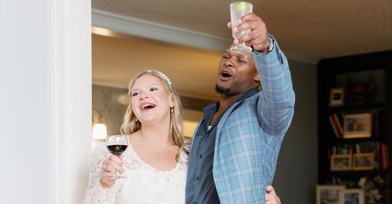 couple toasting after planning an pre-wedding engagement party