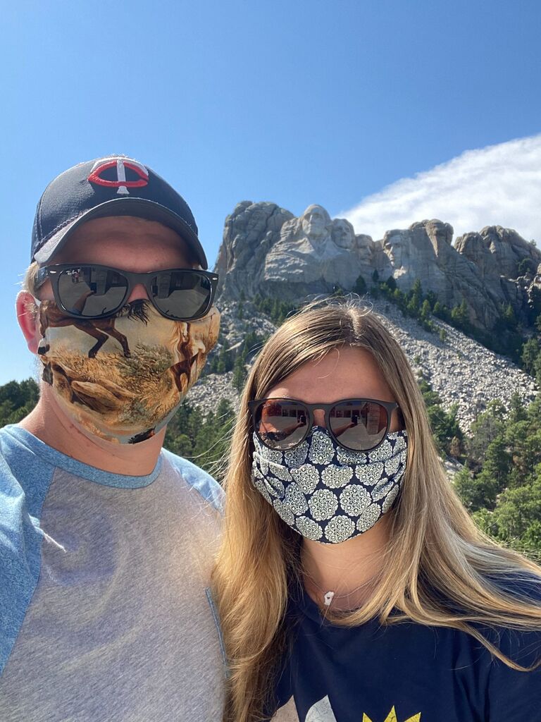 Covid camping trip to the Badlands and Mount Rushmore. We are smiling because Grace's car is not totaled from a freak hailstorm (yet...). Hailstorm can be seen above Abraham Lincoln's head.