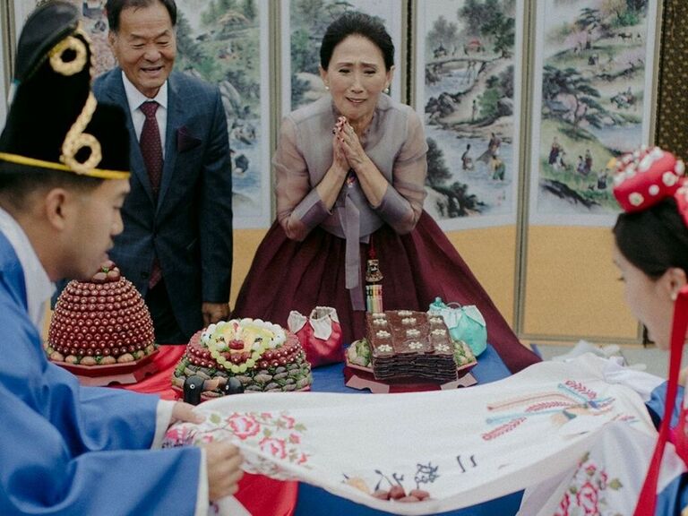 Couple participating in pye-baek ceremony at Korean wedding