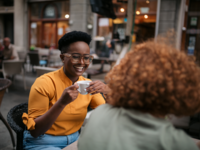 Sisters-in-law talking with each other over coffee