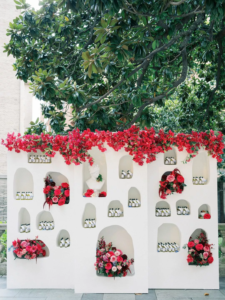 Greek-Inspired Escort Card Wall in bright pink flowers