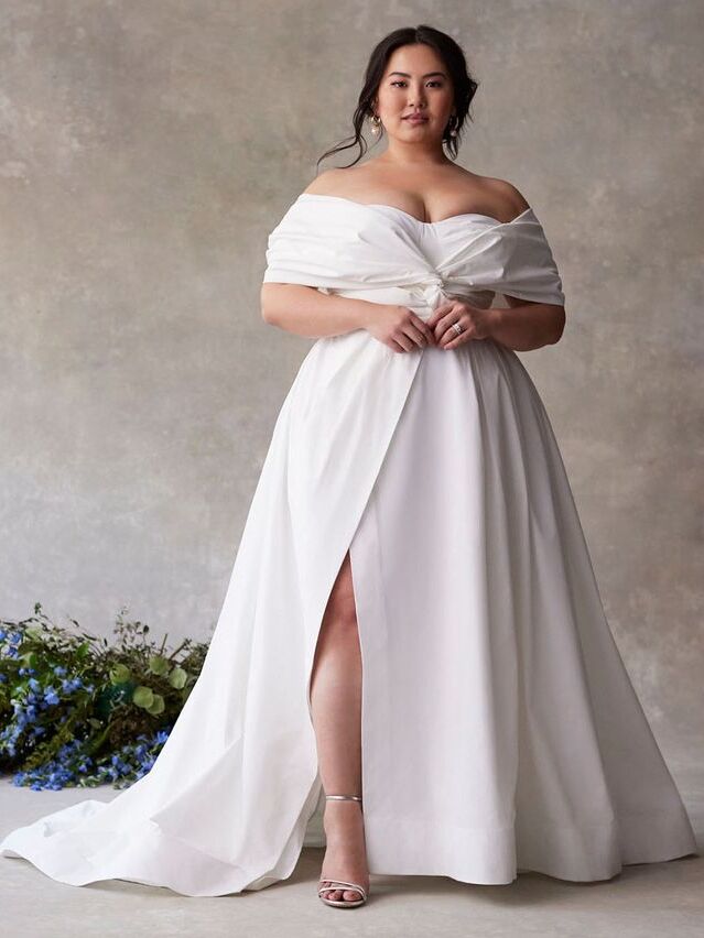 Model wearing a twisted off-the-shoulder affordable gown. 