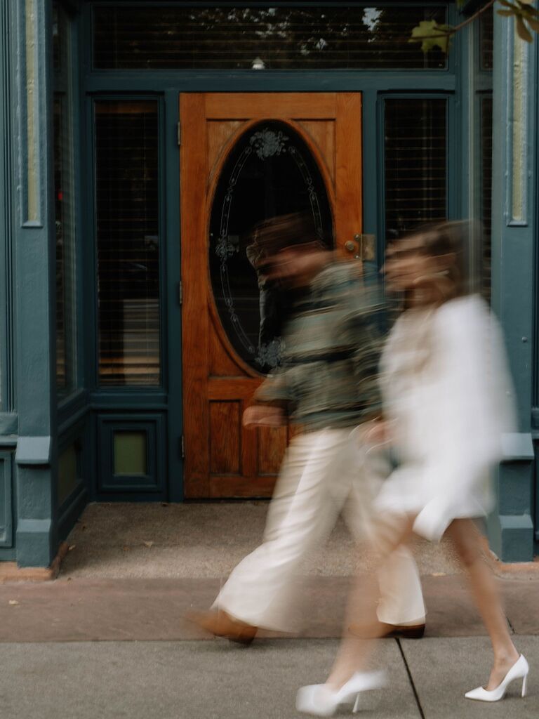 Action photo of couple walking down street