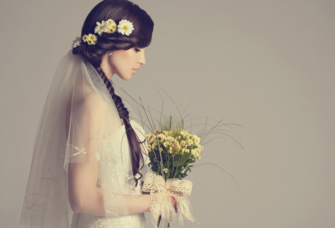 Bride with long hairstyle holding bouquet