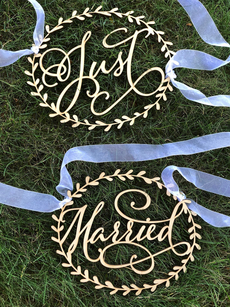 Wooden 'Just Married' chair signs in calligraphy with wreath