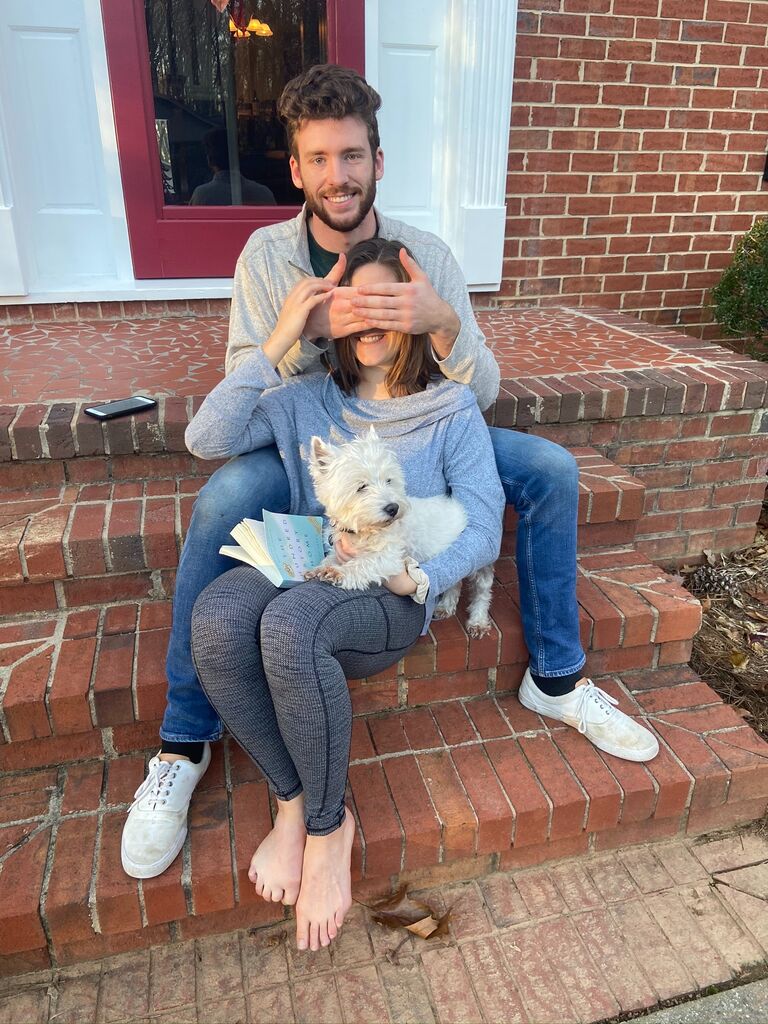 Hallie smiling in embarrassment as Tom is not just weird in front of her, but her family too. 