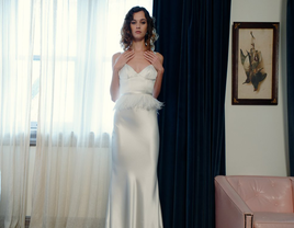 Satin-backed crepe sheath column gown with feather detail at waist