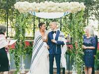 Couple under chuppah at Jewish wedding ceremony