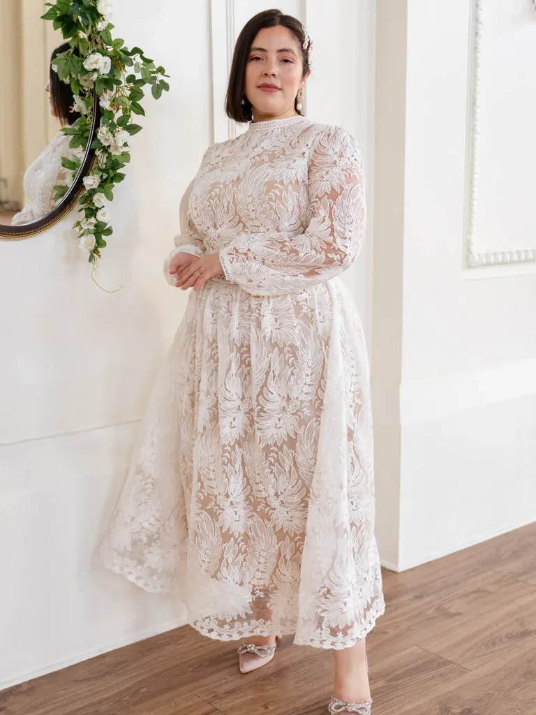 Bride in long sleeve white lace dress