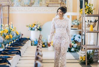 Woman walking in a bridal shower event space surrounded with blue and yellow florals