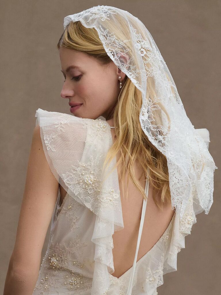 Model wears a beautiful lace veil. 