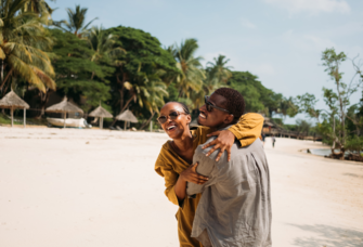 Couple on beach in Tanzania, July honeymoon destinations